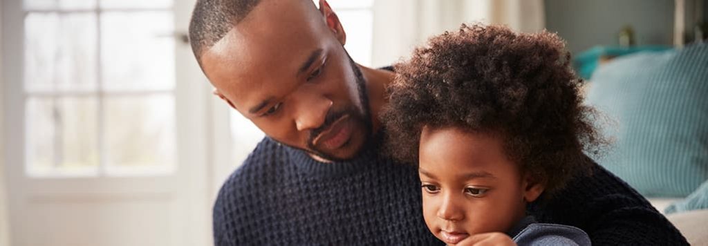 Man reading to his son