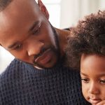 Man reading to his son